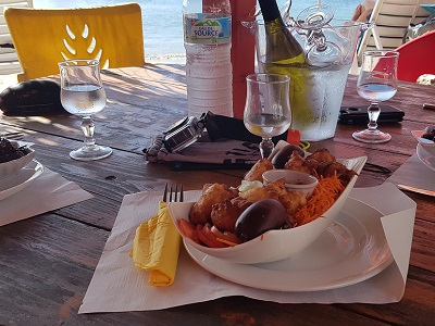Lunch on the beach of Grand Anse d'Arlet. Typical Caribbean fried stuff (accras) with fries and vegetables.