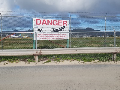 Warning sign at the famous Sint-Maarten beach, which dramatically describes why people go there in the first place. 'Cake or death?'