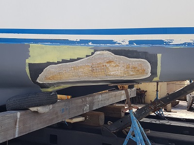 The exposed foam core in preparation of repairing the outer layer.